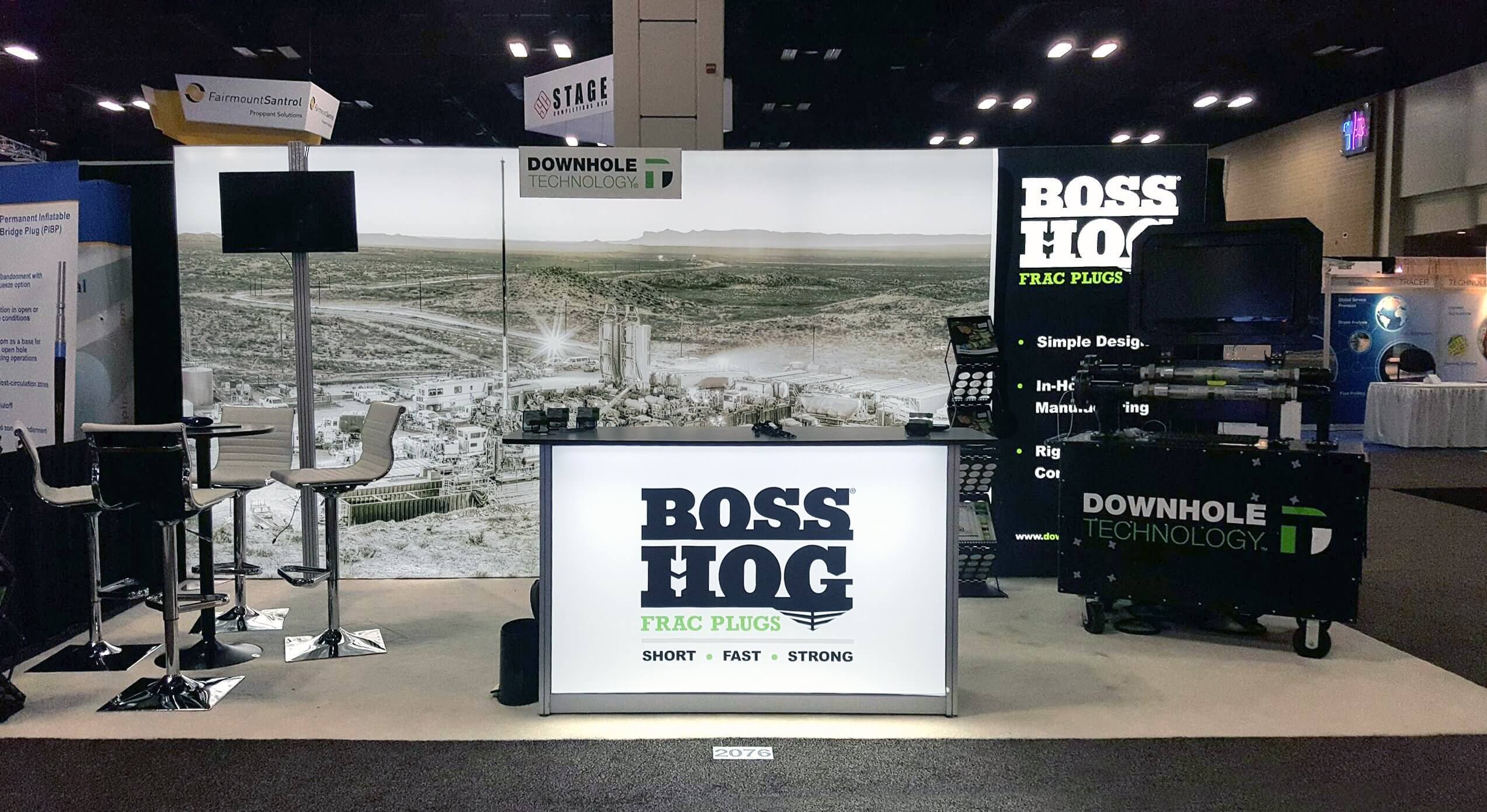 Modern and cutting-edge branded 10 x 20 backlit fabric exhibit and backlit counter with seating area.
