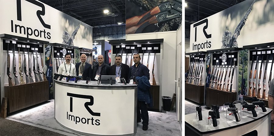 Trade show team at the podium of the booth at the Shot Show and backlit gun display case at the World Wide Buying Group Show