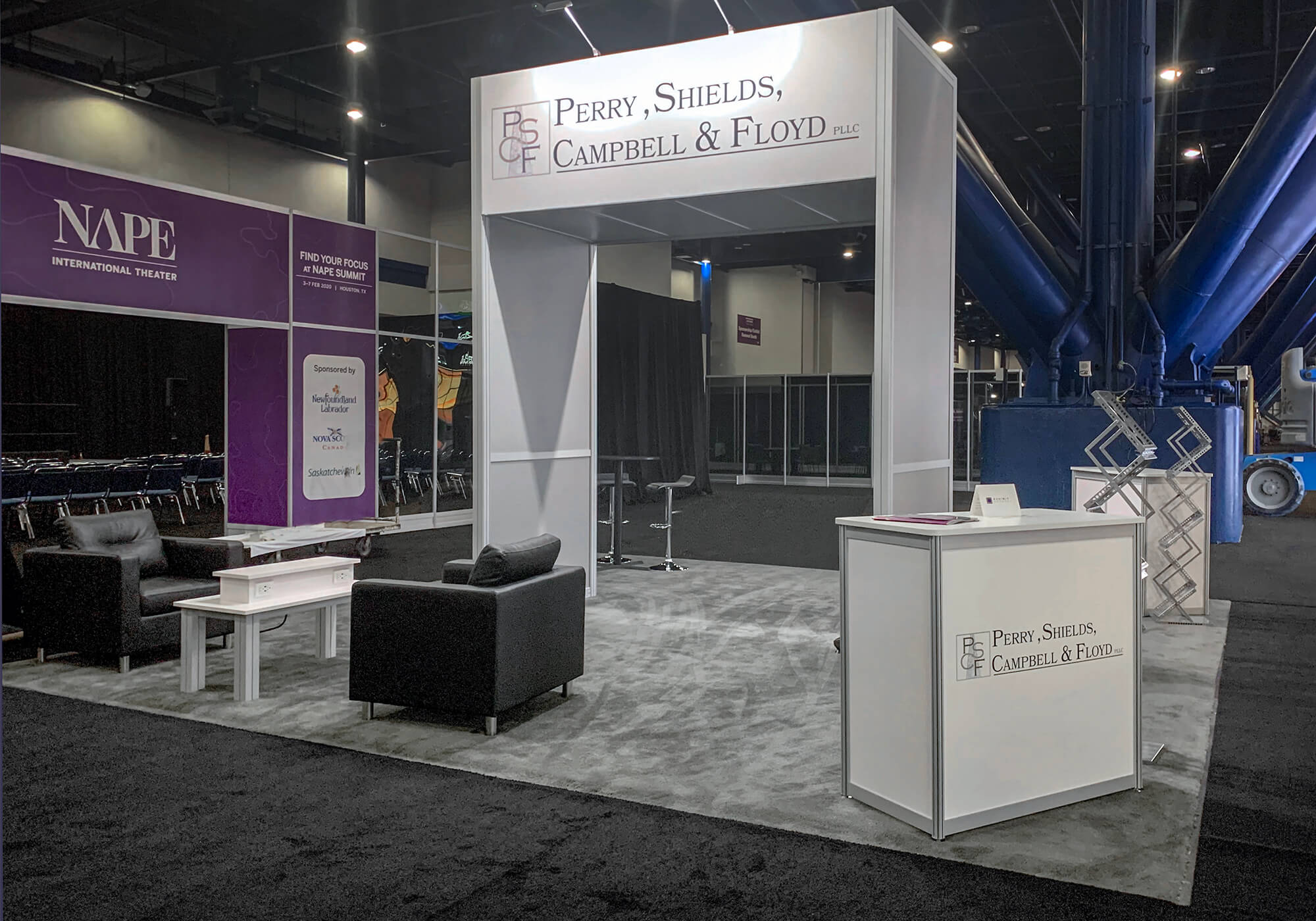 White, lit, two-sided, co-branded booth with comfortable leather seating for the NAPE Summit and Energy Business Conference.