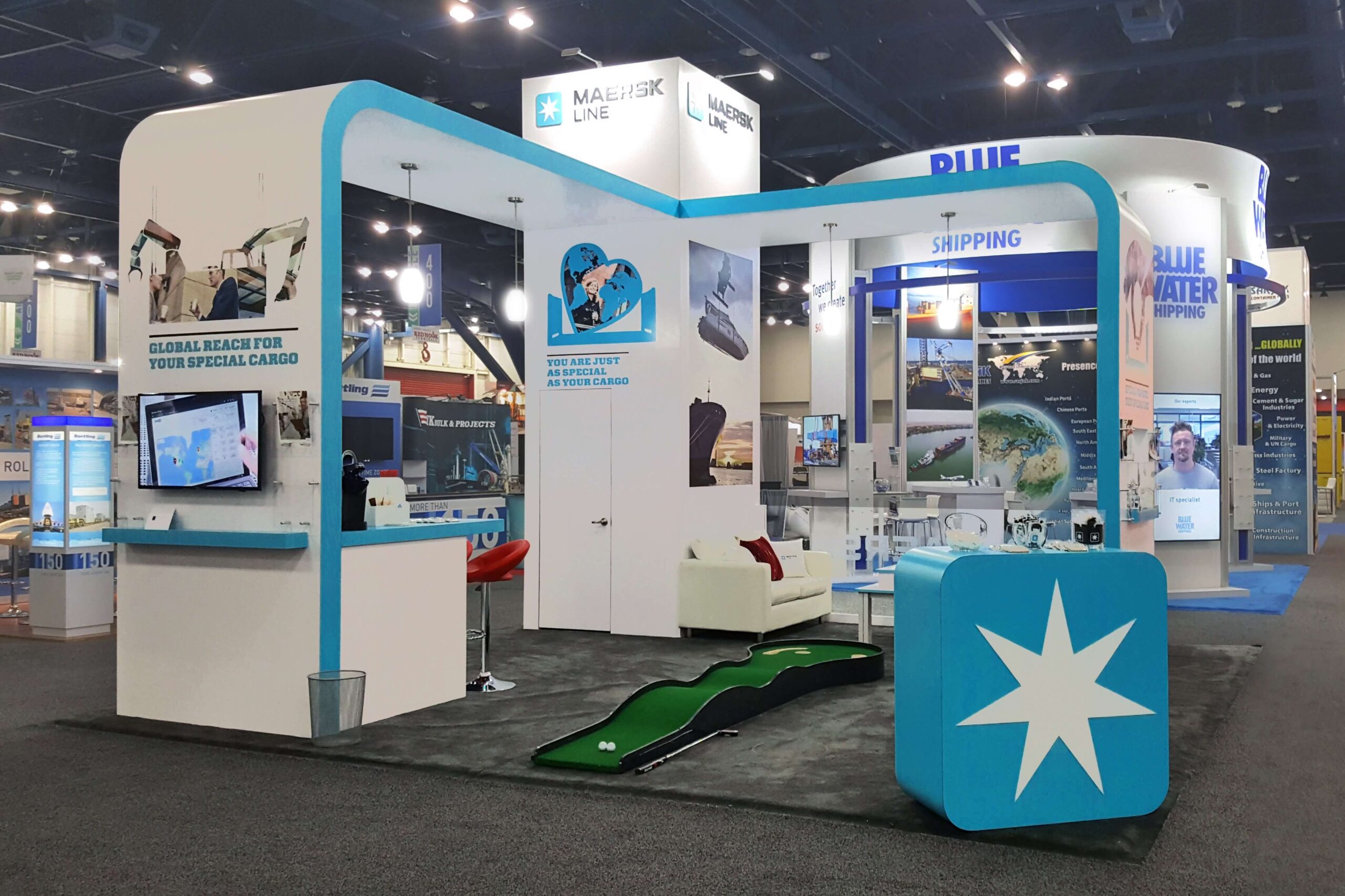 20×20 custom exhibit with semi-private meeting area, interactive touchscreen, video monitors, iPad stands, charging stations
