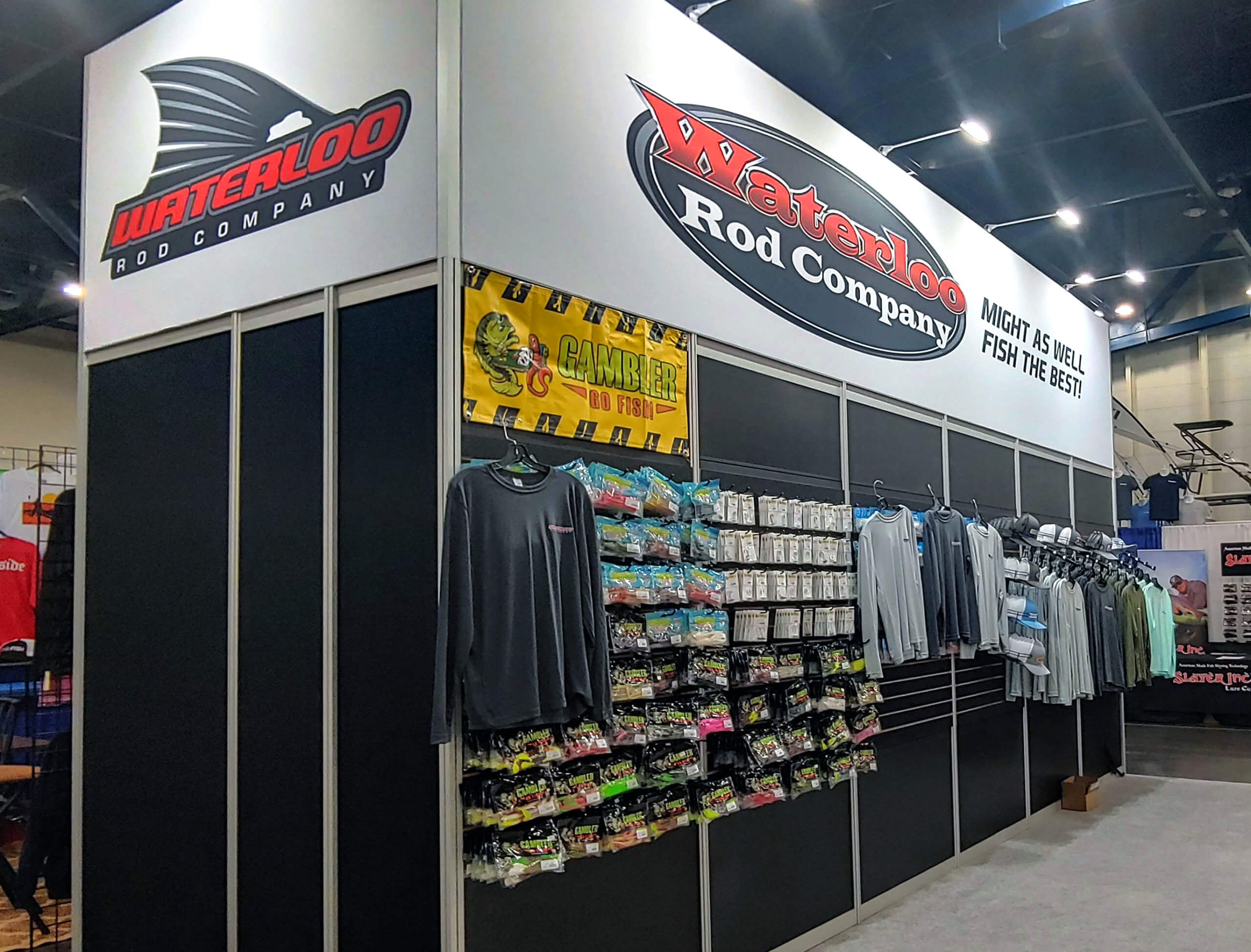 Large booth branded for Waterloo Rod Company on all sides. Custom fishing rods hang on the back wall, adding more floor space