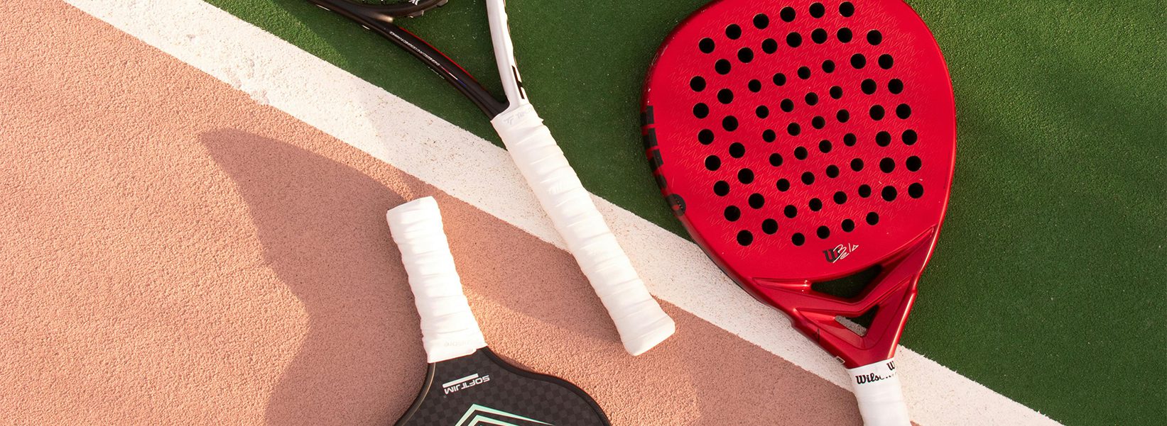 Tennis, paddle, and pickleball rackets on grass and clay courts represent Exhibit Network enabling client success at sporting goods trade shows like ICAST, SHOT SHOW, and Great American Outdoor Show